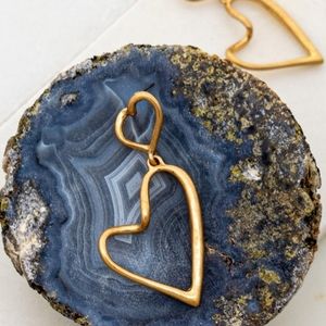 Gold double linked heart hoop earrings.